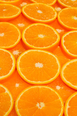 Slices of oranges as a background, top view.