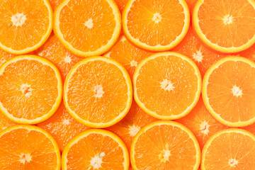 Slices of oranges as a background, top view.