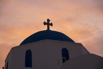Typical silouette of the dome of a church in Greece with a sunset