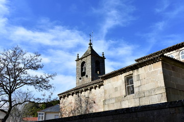 Fototapeta na wymiar Romanesque medieval San Esteban Church. Bell tower and tree, side view. Allariz, Orense, Spain.