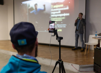A man with a tripod shoots a live stream on Instagram