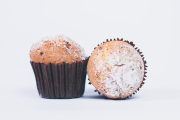 Chocolate homemade muffins whith sugar powder isolated on white, selective focus