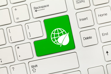 White conceptual keyboard - Green key with Earth and leaf symbol