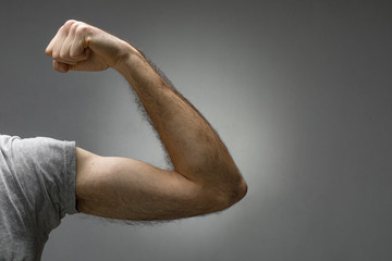 Close-Up of a Thin Hairy Arm Contracting the Biceps