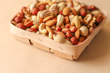 Dried fruits and nuts mix in a wooden bowl. 