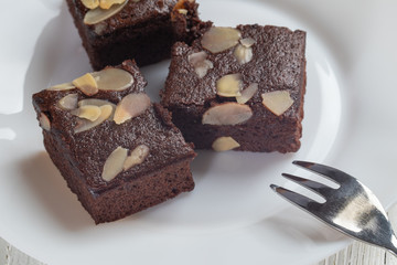 close up of delicious chocolate brownie cake in white plate