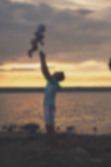 Blurred - Young father and his daughter at sunset on the lake.