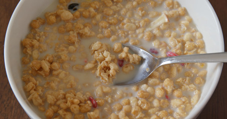 Fototapeta na wymiar Adding milk into cereal