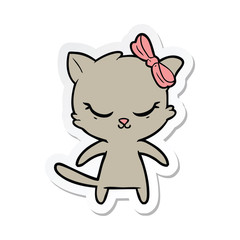 sticker of a cute cartoon cat with bow