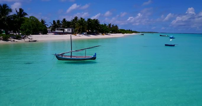 Maldives Dhoni boat floating on crystal clear waters in Indian ocean, 4k pan