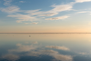 White clouds reflecting in calm water