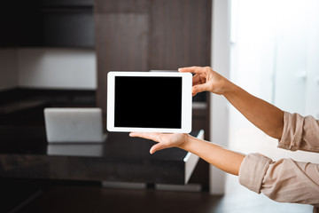 selective focus of woman holding digital tablet with blank screen