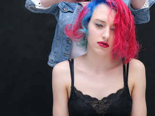 Portrait of a hairdresser makeup artist beautician. Model with red multi-colored hair. Head...