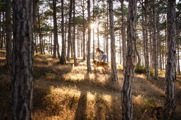 Obraz premium young beautiful woman walking with collie dog.
