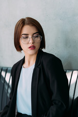 Superior young woman portrait. Business colleague. Dissatisfied facial expression.
