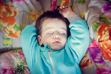 the boy is sleeping. little baby is sleeping sweet sleep baby. boy in a blue fleece suit