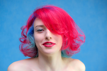 High fashion model woman with multi-colored hair posing in the studio, portrait of a beautiful sexy...