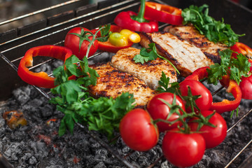 meat steaks with greens and vegetables on the grill