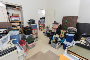 Messy back office with boxes, clutter old equipment and miscellaneous storage.  