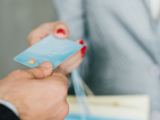 Credit card payment. Female shopping lifestyle. Woman with bags purchasing with plastic money.