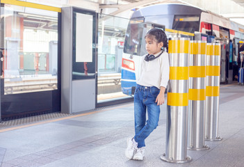 Naklejka na ściany i meble portrait asian kid portrait posting on sky train in capital urban lifestyle