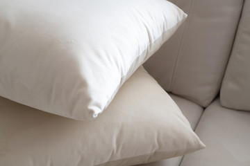Fototapeta na wymiar Two White pillow on the light sofa