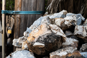 Background of large stones with palm leaves. 4k.