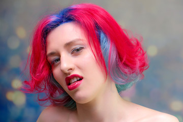 High fashion model woman with multi-colored hair posing in the studio, portrait of a beautiful sexy girl with a fashionable makeup