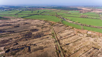 aerial view of peat bog and grass fields landscape in rural Ireland