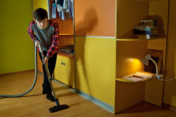 The guy picks up the room. Wardrobe and clothes in the children's room.