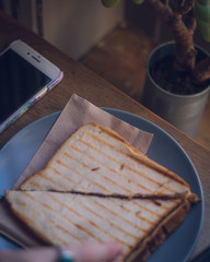 toastie, plant and iPhone at sandwich bar
