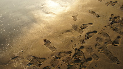 Sandy beach sunset Footsteps