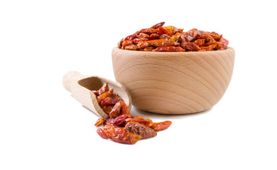 chili peperoncini paprika pepper in wooden bowl and scoop isolated on white background. Spices and food ingredients.