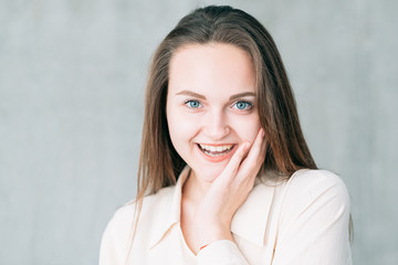 Excited young woman portrait. Youth and beauty. Skin care. Attractive female touching face.