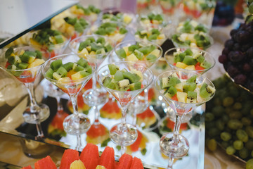 Candy bar with fruit decorated in glasses. Background texture