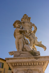 The leaning tower of pisa at Piazza del Miracoli Duomo square with medieval statue in Tuscany, Italy