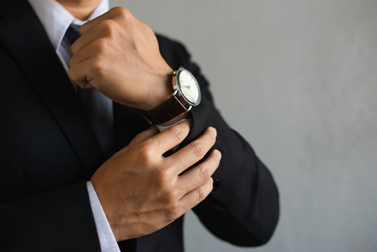 Closeup Watch On Hand Businessman, He Checking Time On Watch,Businessman Wearing Suit With A Smart Modern Watch Is Thinking On White Background,copy Space.