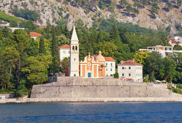 Beautiful summer Mediterranean landscape. Montenegro, Adriatic Sea, Bay of Kotor. View of Church of St. Matthew in Dobrota town ( near Kotor city ) from the sea