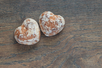 two gingerbread in the shape of a heart on the background of an old blackboard with copy-space