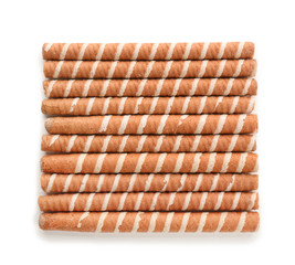 Tasty wafer roll sticks on white background, top view. Crispy food