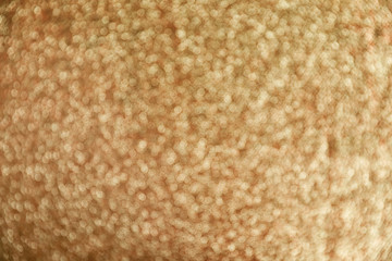 Gold glitter with bokeh effect as background, closeup