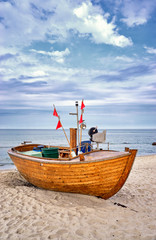 Naklejka na ściany i meble Old wooden fishing boat at the Baltic Sea in Binz. Island Rügen, Germany