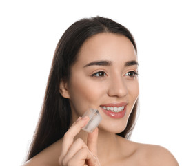 Obraz premium Young woman with ice cube on white background. Skin care