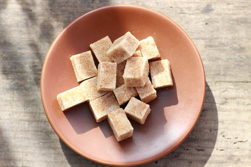 brown sugar lumps on the brown saucer