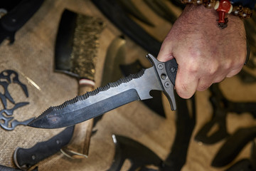 knife multitool turned into pliers in the hands of a man.