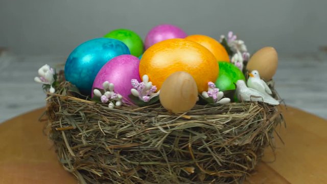 The symbol of Easter dyed and painted colored eggs are in the nest, concept of Resurrection Sunday or Christian feast Pascha