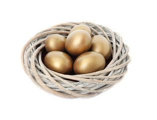 Golden eggs in nest on white background