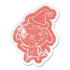 happy cartoon distressed sticker of a dog wearing santa hat