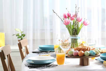 Festive Easter table setting with traditional meal, space for text