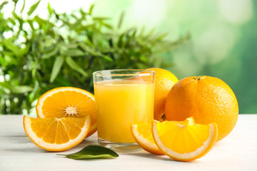 Composition with orange juice and fresh fruit on table